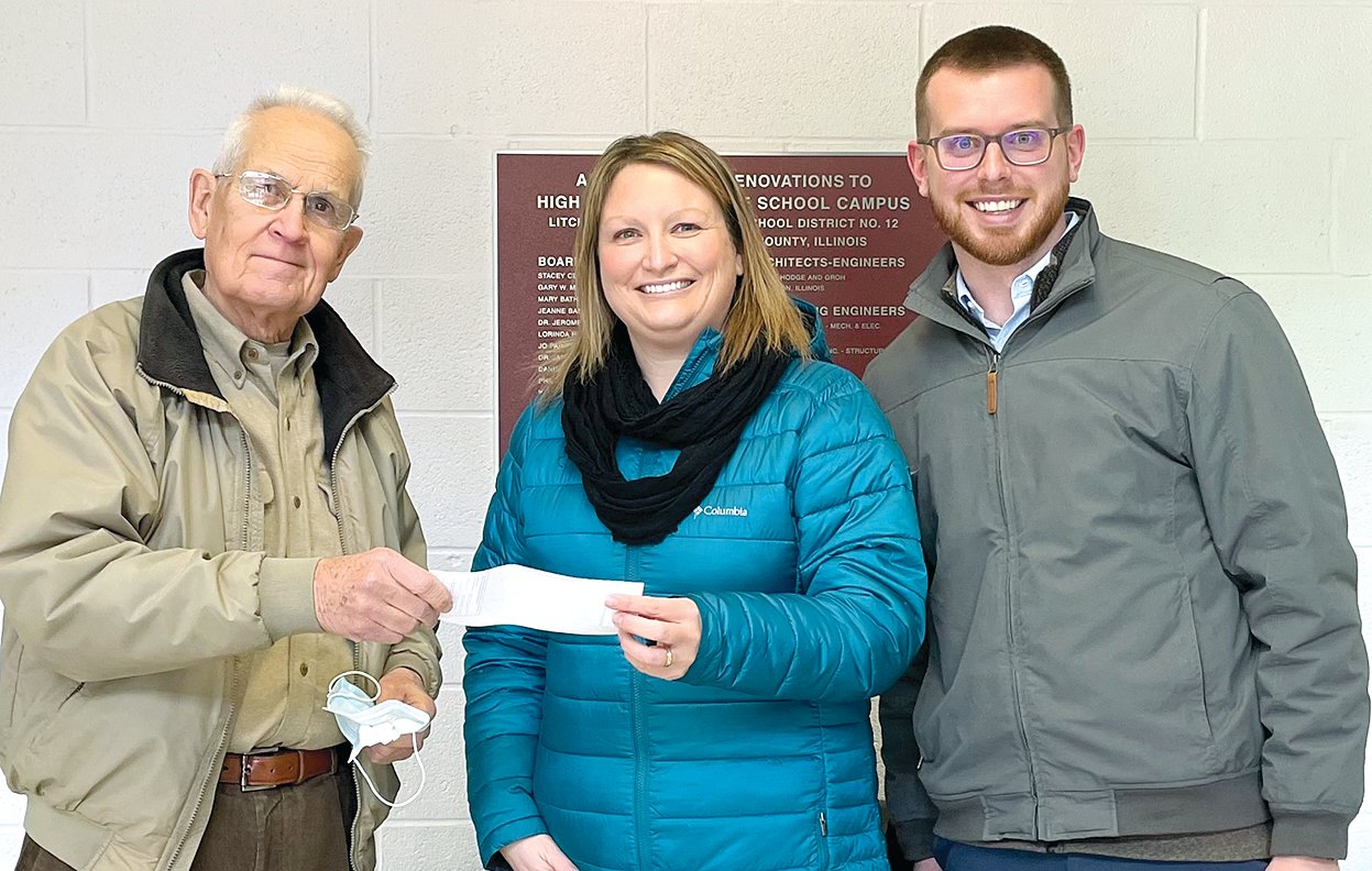 Dr. Ross Billiter of Litchfield, at left, presents a $20,000 donation to Litchfield Student Education Foundation board members Julie Abel, center, and Mike Delaney.